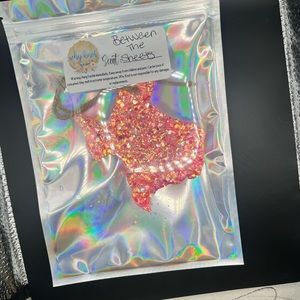 Light pink, TX shaped, “Between the sheets” like car scented car candle